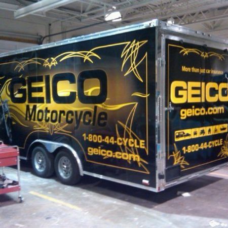 railer parked inside of a garage with wrapping for Geico Motorcycle insurance