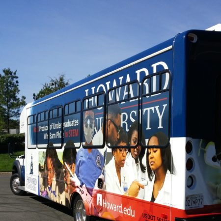 Side angle of a parked bus with Howard University vehicle wrapping