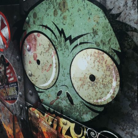 Close up view of a faded alien face and decorative biohazard stickers on a Pho Junkies food truck